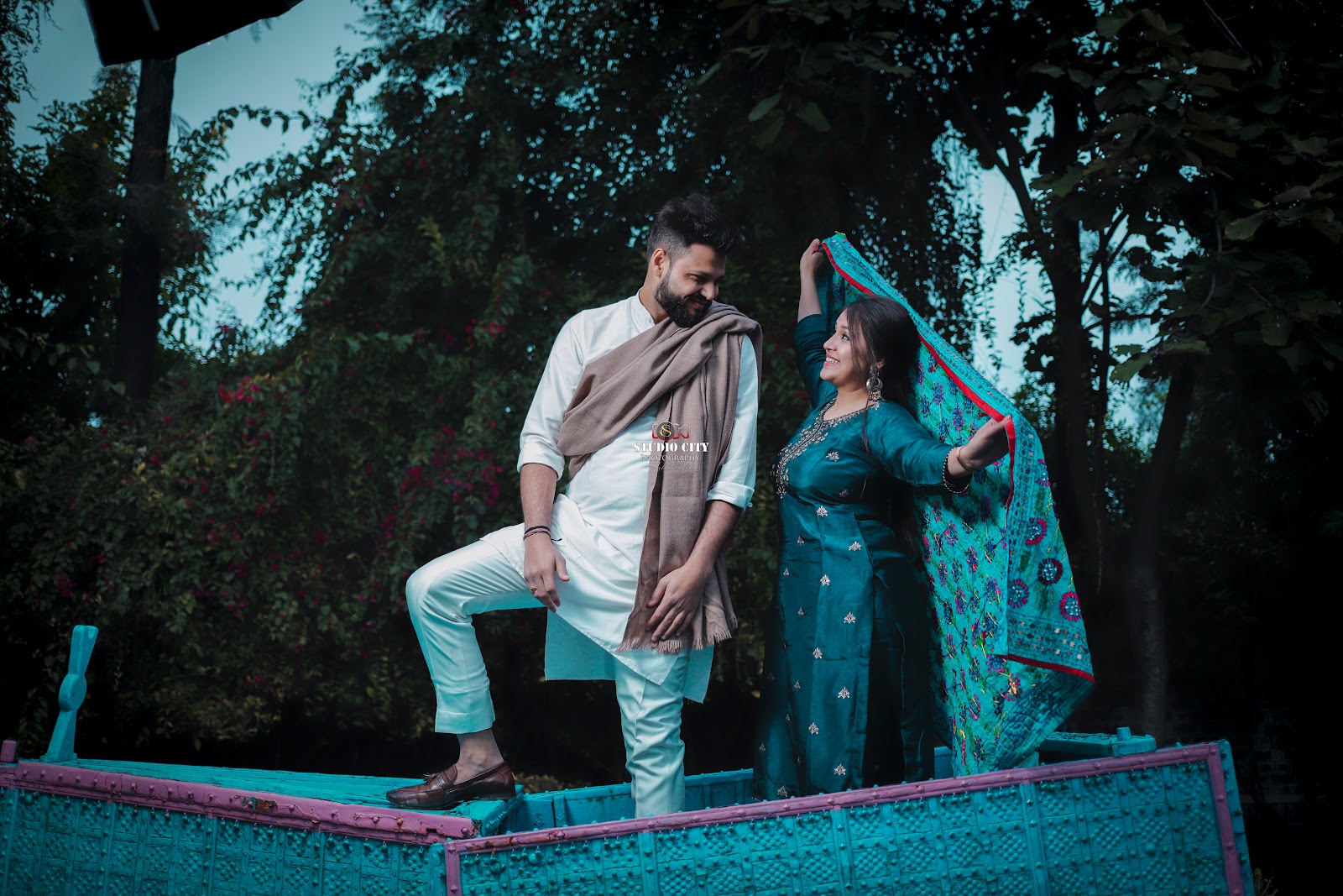 Couple portrait outdoors among greenery